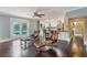 Open-concept living space with hardwood floors, comfortable seating, and a view of the modern kitchen at 120 E Greentree Ln, Lake Mary, FL 32746