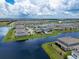 Real estate featuring lush green lawns and backyard pools, situated in a desirable community by the water at 13822 Destin Beach Ln, Orlando, FL 32827
