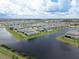 Gorgeous aerial view of a Primary-planned community with waterfront homes and manicured landscaping at 13822 Destin Beach Ln, Orlando, FL 32827