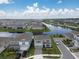 A scenic aerial view showcasing a well-planned community with houses near a winding lake at 13822 Destin Beach Ln, Orlando, FL 32827