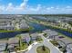 Panoramic aerial view of a community, highlighting a network of lakes and houses with manicured lawns at 13822 Destin Beach Ln, Orlando, FL 32827