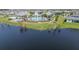 Aerial view of community pool, lake, and clubhouse featuring poolside seating at 13822 Destin Beach Ln, Orlando, FL 32827