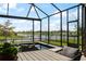 Relaxing screened-in back porch with a view of the lake, creating a serene outdoor living space at 13822 Destin Beach Ln, Orlando, FL 32827