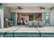 Gorgeous back porch area with outdoor seating and views into the kitchen and backyard pool at 13822 Destin Beach Ln, Orlando, FL 32827