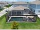 Aerial view showcasing the screened pool, patio furniture, and fenced yard of this home at 13822 Destin Beach Ln, Orlando, FL 32827