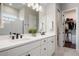 Well-lit bathroom featuring double vanity sinks, modern fixtures, and a walk-in closet at 13822 Destin Beach Ln, Orlando, FL 32827