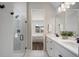 Modern bathroom with walk-in glass shower, double vanity, and a view into the bedroom at 13822 Destin Beach Ln, Orlando, FL 32827