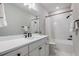 Modern bathroom features a large mirror, sleek vanity with a white countertop and bathtub at 13822 Destin Beach Ln, Orlando, FL 32827