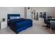 This bedroom features a blue bed, a nearby closet and an expansive workstation at 13822 Destin Beach Ln, Orlando, FL 32827
