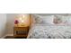 Inviting bedroom featuring floral bedding, decorative pillows, and a stylish nightstand at 13822 Destin Beach Ln, Orlando, FL 32827