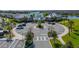 Community center with a circular driveway, parking, lush landscaping, and a glimpse of the lake at 13822 Destin Beach Ln, Orlando, FL 32827