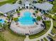 Aerial view showcasing the community pool with ample lounge chairs and palm trees at 13822 Destin Beach Ln, Orlando, FL 32827