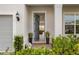 Welcoming front entrance with lush greenery, lantern and view into the living room at 13822 Destin Beach Ln, Orlando, FL 32827