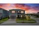 Beautiful two-story home with colorful sunset creating a warm and inviting ambiance at 13822 Destin Beach Ln, Orlando, FL 32827