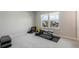 Bright home gym with large windows, exercise bench, free weights, and neighborhood views at 13822 Destin Beach Ln, Orlando, FL 32827