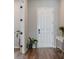 Hallway featuring laminate flooring, a door on one side and an office table on the other at 13822 Destin Beach Ln, Orlando, FL 32827