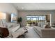 Bright living room boasts modern furnishings and an expansive sliding glass door leading to a patio with a beautiful view at 13822 Destin Beach Ln, Orlando, FL 32827