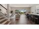 Open-concept living space with an island counter and staircase at 13822 Destin Beach Ln, Orlando, FL 32827