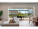 Bright living room view to outdoor living space with a private pool and manicured lawn at 13822 Destin Beach Ln, Orlando, FL 32827