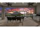 Screened patio at dusk featuring an outdoor dining area and views of the backyard pool and landscaping at 13822 Destin Beach Ln, Orlando, FL 32827
