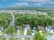 Aerial view of home and neighborhood showcases its proximity to wooded area and lake at 1576 Crosswind Cir, Orlando, FL 32825
