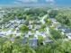 Aerial view of the neighborhood showcases mature trees and landscaping surrounding the property at 1576 Crosswind Cir, Orlando, FL 32825