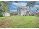The spacious backyard features lush grass, a storage shed, and a privacy fence at 1576 Crosswind Cir, Orlando, FL 32825