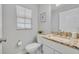Bathroom with granite countertops, toilet, and window at 1576 Crosswind Cir, Orlando, FL 32825