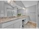 Bathroom featuring double sinks, granite counters, vanity and a glass enclosed shower at 1576 Crosswind Cir, Orlando, FL 32825