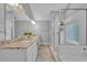 Well-lit bathroom featuring double sinks, granite countertops, and a glass-enclosed shower at 1576 Crosswind Cir, Orlando, FL 32825