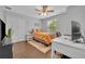 Bright bedroom featuring hardwood floors, closet and an orange comforter at 1576 Crosswind Cir, Orlando, FL 32825