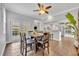 Dining room with wood floors, modern lighting, and an open view into the kitchen area at 1576 Crosswind Cir, Orlando, FL 32825