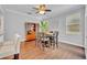 Inviting dining room with hardwood floors, a ceiling fan, and a stylish wooden china cabinet at 1576 Crosswind Cir, Orlando, FL 32825