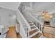 Bright foyer with staircase and wood floors, offering a glimpse into the living area at 1576 Crosswind Cir, Orlando, FL 32825