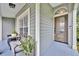 Inviting covered front porch featuring a glass front door, potted plants, and a cozy bench at 1576 Crosswind Cir, Orlando, FL 32825