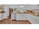 Bright kitchen featuring granite countertops, stainless steel dishwasher, and white cabinetry at 1576 Crosswind Cir, Orlando, FL 32825