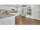 Spacious kitchen boasts stainless steel appliances, white cabinets, and hardwood flooring at 1576 Crosswind Cir, Orlando, FL 32825