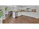 Open concept kitchen with stainless appliances, hardwood flooring, and access to the dining room at 1576 Crosswind Cir, Orlando, FL 32825