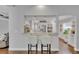 View into a modern kitchen featuring white cabinets, stainless steel appliances, and granite countertops at 1576 Crosswind Cir, Orlando, FL 32825