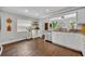 Kitchen with granite counters, stainless appliances, and hardwood floors with a view into the dining room at 1576 Crosswind Cir, Orlando, FL 32825