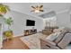 Comfortable living room featuring hardwood floors, a ceiling fan, and a modern TV at 1576 Crosswind Cir, Orlando, FL 32825