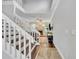 Bright entryway with a white staircase leading to the upper level and a glimpse into the living area at 1576 Crosswind Cir, Orlando, FL 32825