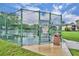 Community tennis court is enclosed by a tall fence with a gate and posted rules at 1576 Crosswind Cir, Orlando, FL 32825
