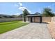Spacious backyard with a modern gazebo, artificial turf, and stylish concrete patio at 1727 Butterfly Way, Longwood, FL 32750