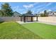 Backyard featuring synthetic grass, a gazebo, and a fenced perimeter at 1727 Butterfly Way, Longwood, FL 32750