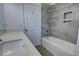 Bathroom featuring a gray-tiled shower-over-tub, white vanity with white countertop, and wood-look flooring at 1727 Butterfly Way, Longwood, FL 32750