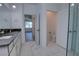 Bright bathroom features double vanity, tile floor, and an open doorway to a bedroom and separate water closet at 1727 Butterfly Way, Longwood, FL 32750