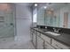Modern bathroom featuring double vanity, marble-look shower, and stylish fixtures at 1727 Butterfly Way, Longwood, FL 32750