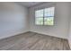 Cozy bedroom with bright window and wood-look flooring, perfect for relaxation at 1727 Butterfly Way, Longwood, FL 32750