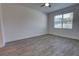 Bedroom featuring neutral walls, wood-look floors, and a window providing natural light at 1727 Butterfly Way, Longwood, FL 32750
